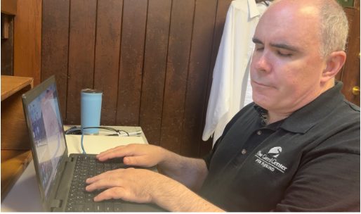 a man working with a laptop at the Carroll Center