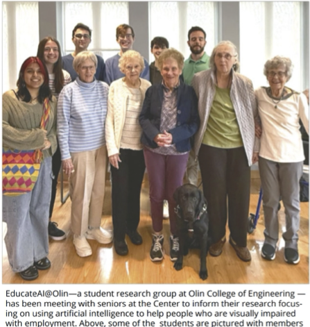 Olin students posing for a group picture with seniors at a Needham senior center